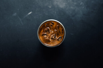 Close-up of iced coffee served on black table at cafe​