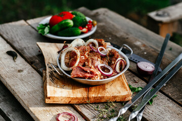 Marinated pork for shish kebab in an iron micron. Raw meat