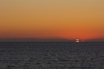 Naklejka na ściany i meble Sunset on the sea, on the Atlantic Ocean
