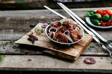 Marinated pork for shish kebab in an iron micron. Raw meat