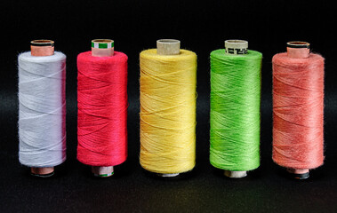 five colored coils on a black background