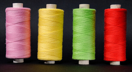 four colored coils on a black background