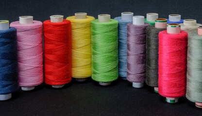 background of colorful spools of thread