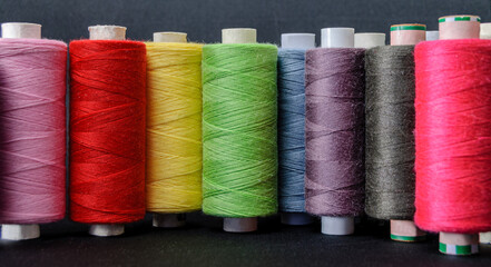 background of colorful spools of thread
