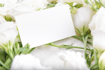 Horizontal 3,5x2 empty card mockup with blooming white eustoma lisianthus flowers, design element for wedding business card, thank you or greeting card. Spring background
