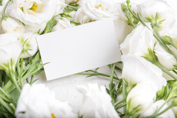 Obraz na płótnie Canvas Horizontal 3,5x2 empty card mockup with blooming white eustoma lisianthus flowers, design element for wedding business card, thank you or greeting card. Spring background