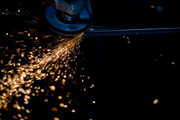 Sparks from cutting metal. Grinding of steel. High temperature causes sparks. Friction force on the...