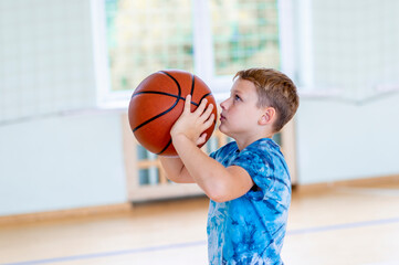 School kid playing basketball in a physical education lesson. Horizontal education poster, greeting cards, headers, website. Safe back to school during pandemic concept