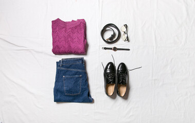 Women's clothing and accessories installed on a white background top view. A modern and casual outfit. Fashion, shopping and makeup concept. flat lay, the view from above.