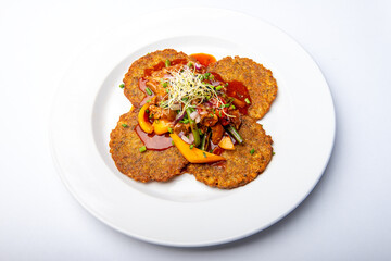 Potato pancakes with meat mixture and vegetables