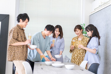 みんなで食事をする若い男女