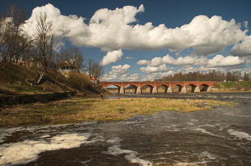 Long brick bridge in sunny spring morning, Kuldiga, Latvia. 