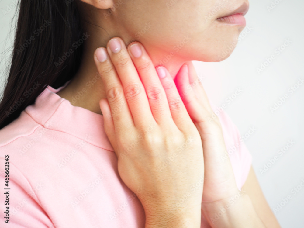 Wall mural Woman suffering from sore throat on white background. closeup photo, blurred.