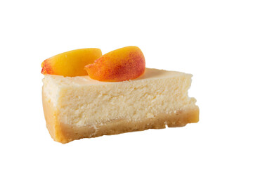 Cheesecake with slices of peach on plate isolated on white background.