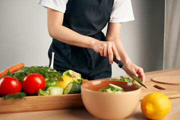 cooking salad with fresh vegetables slicing in the kitchen