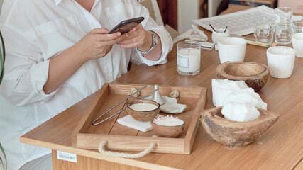 woman entrepreneur makes stylish photos on a smartphone to advertise herself on social networks. promotion in the internet, smm