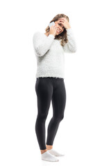 Fototapeta premium Happy laughing young woman woken up woman with tousled hair talking on the cellphone. Full-length portrait isolated on white background