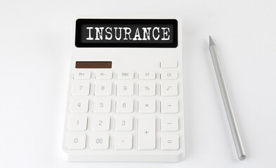 INSURANCE business text on the calculator with pencil