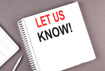 LET US KNOW text on the notebook with calculator and pen