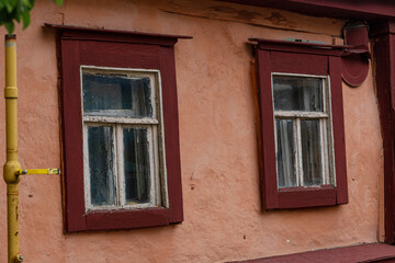 Fototapeta na wymiar A beautiful old window in a carved wooden frame, Russia, Tula.