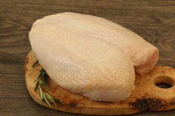 Raw whole chicken breast with skin