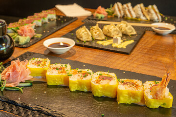 Sushi uramaki dragon roll with shrimp in tempura and red tuna in Japanese restaurant