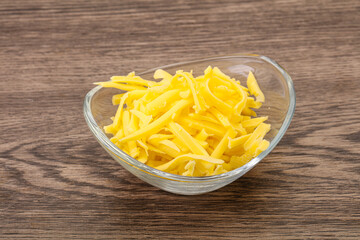 Shredded yellow cheese in the bowl