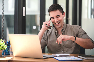 Obraz premium Surprised young man receives an SMS message with a cash prize on a smartphone device. The man was very happy and excited. That has been very profitable.
