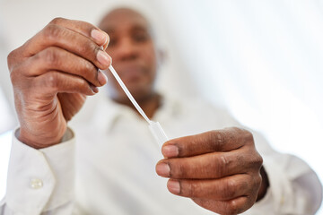 Man does a Covid-19 antigen test with a saliva sample