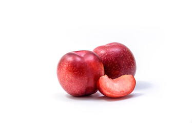 Raw Organic Red Plums on white background, fresh shiny fruits. Farm fresh organic red plums produce on white background