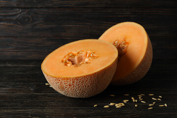 Ripe melon halves on rustic wooden table