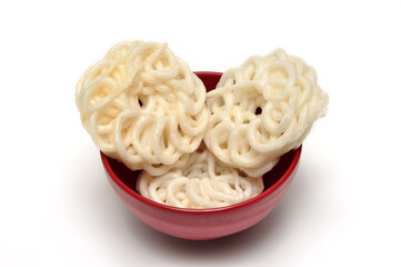 Kerupuk crackers in a red bowl on a white background