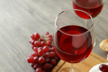 Concept of tasty eating with red wine on gray textured table