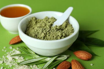 Natural spa cosmetics on green background, close up