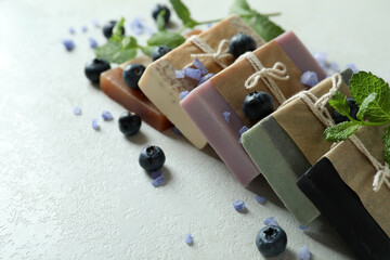 Different natural soap for skin care on white textured table