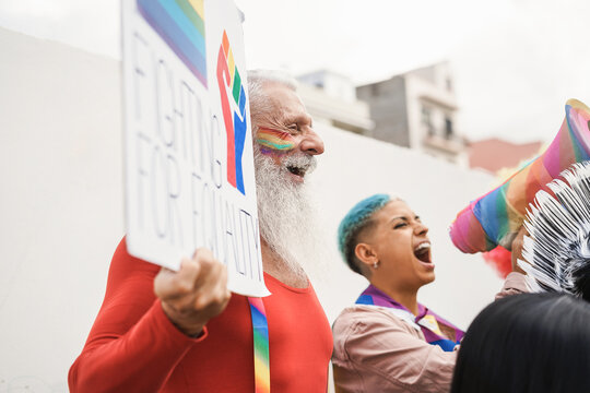 Gay people protest at lgbt pride event outdoor - Focus on hipster senior man face