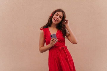 An enthusiastic young attractive singer listens to her new recording with headphones. She is happy with the result and sings along while waiting for the future performance of the new album 