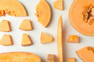 Flat lay with melon slices on white background