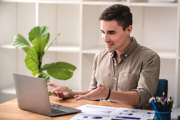 Fototapeta premium business man happily discussing work through laptop