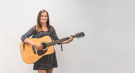 Fototapeta premium Guitar player, woman with guitar, isolated female musician, front view