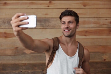 Young european man taking selfie on mobile phone