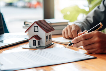 Buying a Home or Insurance, an insurance agent explains the lease agreement to a client before making a contract. Mortgage loan approval home loan and insurance concept. - obrazy, fototapety, plakaty