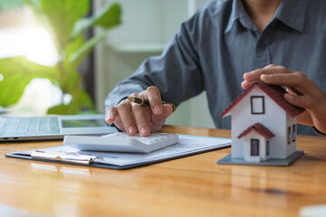 Buying a Home or Insurance, an insurance agent explains the lease agreement to a client before making a contract. Mortgage loan approval home loan and insurance concept.