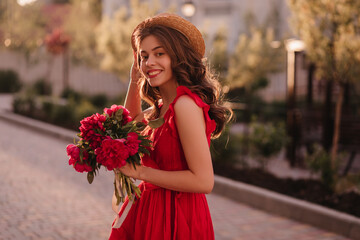 Extremely lovely German girl is walking on the street in a romantic mood before the sunset. She is on her way to poetry evening where young one gonna read her poems very first time. 