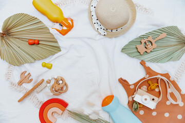 Frame made with Girls Accessories For The Beach. Composition with baby swimsuit on white background. Set of kid beach accessories