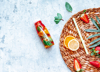Fresh cool detox drink with various berries. Bottle of lemonade or tea. Proper nutrition and healthy eating. Fitness diet. Copy space for text, flat lay
