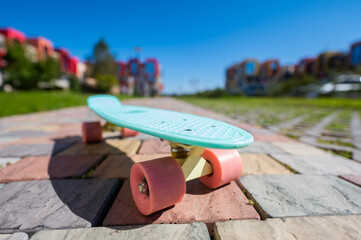 Close-up of a penny board outdoors on a warm summer day.