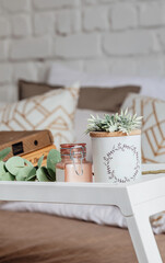 Books on a wooden table with a cup of coffee next to it. Working from home during coronavirus pandemic.