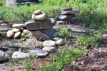 A stack of flat gray stones in the recreation area on the lawn.