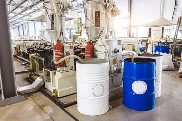 Fototapeta na wymiar The interior of a factory for the production of polypropylene products from recycled materials. Mixing barrels and special equipment
